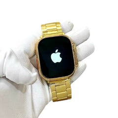 OBtech gold smartwatch with a large 2.3-inch infinite display and a matching gold metal link strap held in a hand