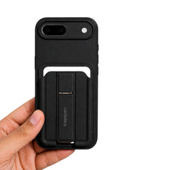 OBtech Spigen black iPhone case with a built-in foldable kickstand held in a hand against a white background.