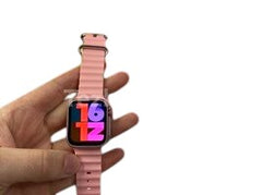 OBtech TK17 Ultra2 Mini smartwatch in light pink with a textured silicone strap held in a hand against black