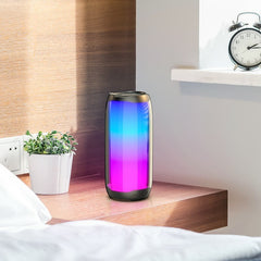 OBtech Hoco HC8 wireless Bluetooth speaker with vibrant pulsating RGB lights on a wooden bedside table