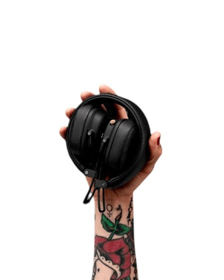 OBtech Marshall Major IV wireless headphones held in a tattooed hand against a black background