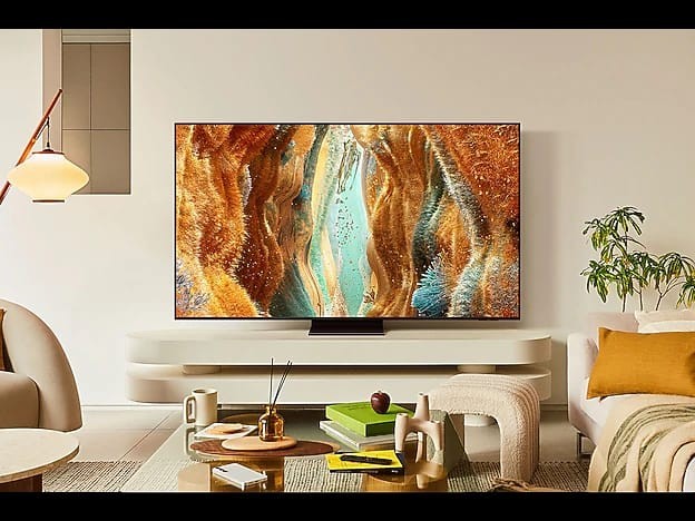 OBtech Samsung 65 inch Neo QLED 4K Smart TV with slim bezel design displaying vibrant abstract art in a living room.