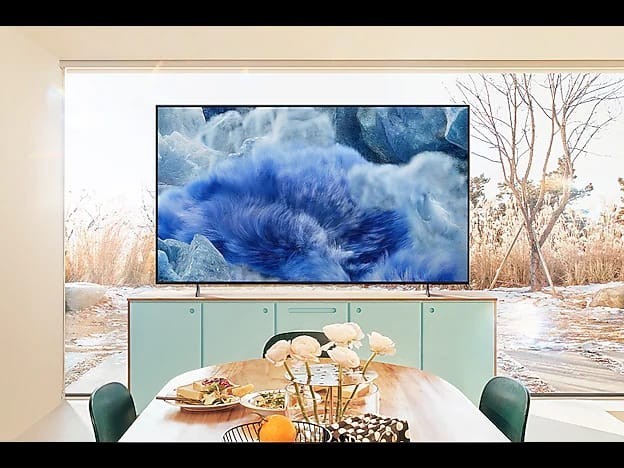 OBtech 65-inch Samsung QLED 4K TV with AirSlim design displaying a blue waterfall scene in a modern living room.