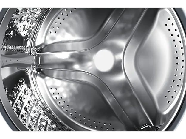 Close-up of the stainless steel interior drum of an OBtech Samsung front-load washing machine with drainage holes.