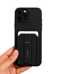 OBtech Spigen iPhone cover in matte black with a built-in foldable kickstand held in a hand against a white background