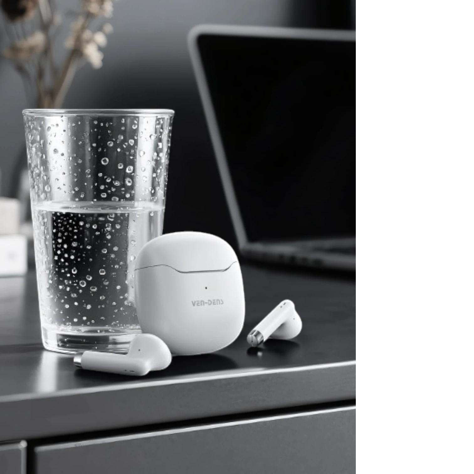 OBtech Ven-Dens VD-BT030 white wireless earbuds and charging case next to a glass of water